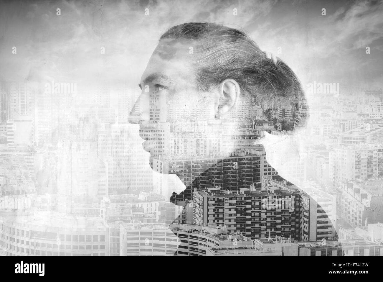 Profilo Ritratto di giovane uomo combinato con paesaggio urbano moderno sotto il cielo nuvoloso, doppia esposizione di un effetto fotografico Foto Stock