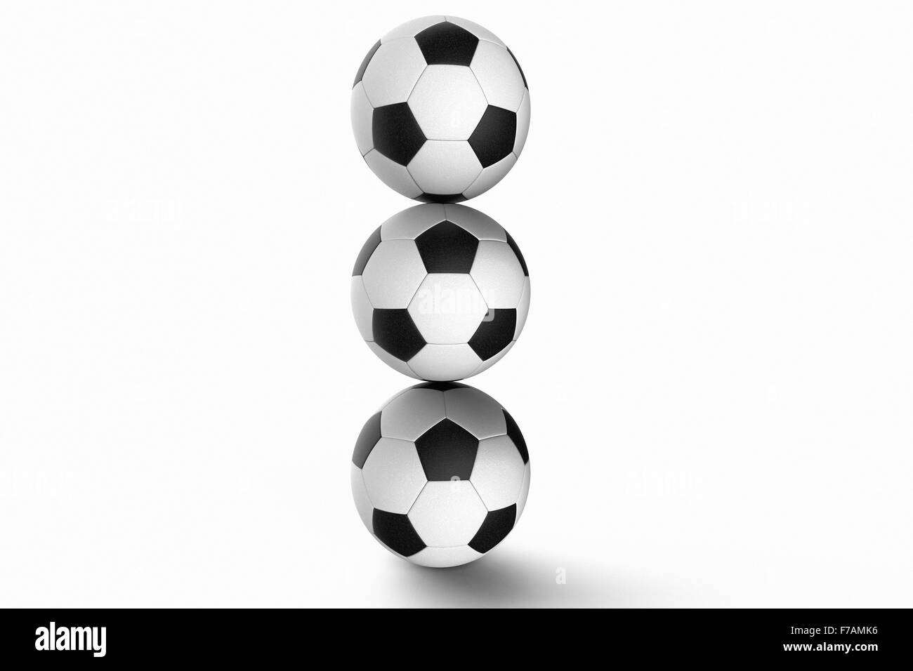 Pila di palloni da calcio contro uno sfondo bianco Foto Stock