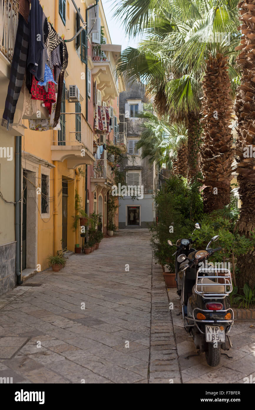 Ciclomotori e lavaggio in una strada posteriore nella vecchia città di Corfù. Corfù Foto Stock