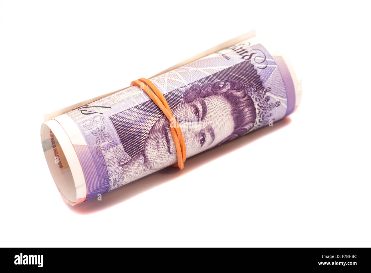 Soldi sterline gbp sotto la banda di gomma isolato Foto Stock