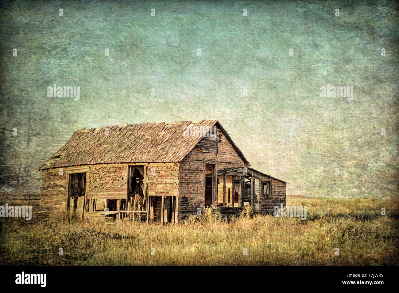 Vecchia fattoria abbandonata su Colorado orientale prairie, grunge e testura sabbiosa foto finish Foto Stock