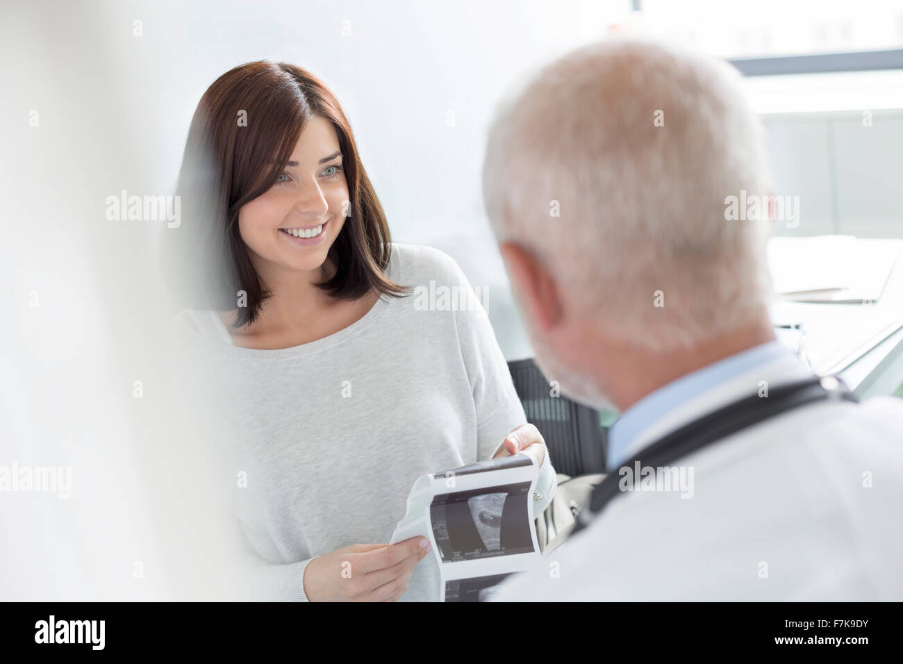 Il medico e il paziente guardando a ultrasuoni raggi x nell'ufficio del medico Foto Stock