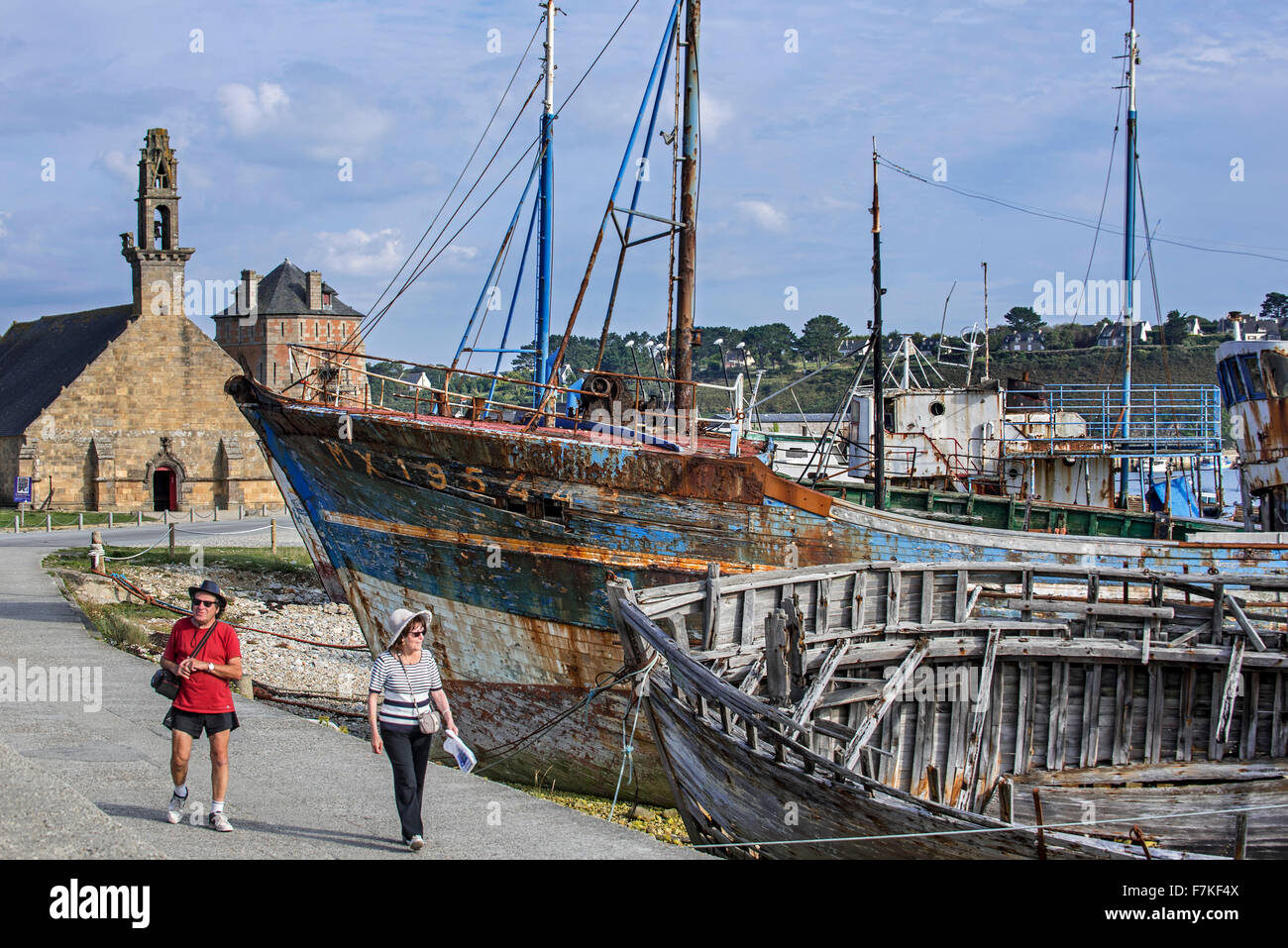 I turisti che visitano i relitti di legno vecchio trawler barche da pesca nel porto di Camaret-sur-Mer Finistère Bretagna, Francia Foto Stock