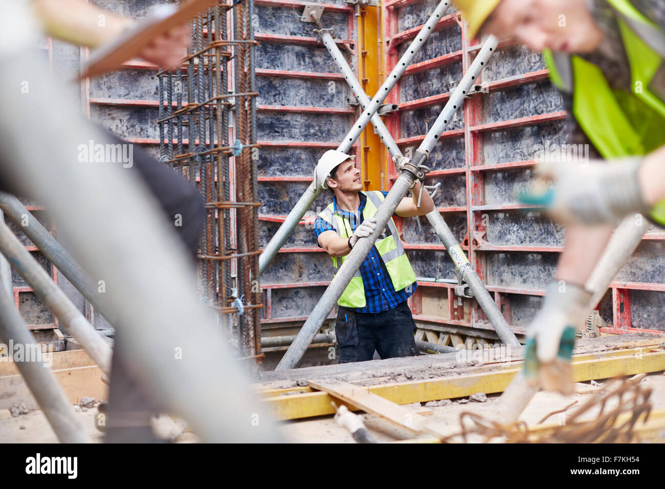 Operaio edile esaminando la struttura al sito in costruzione Foto Stock