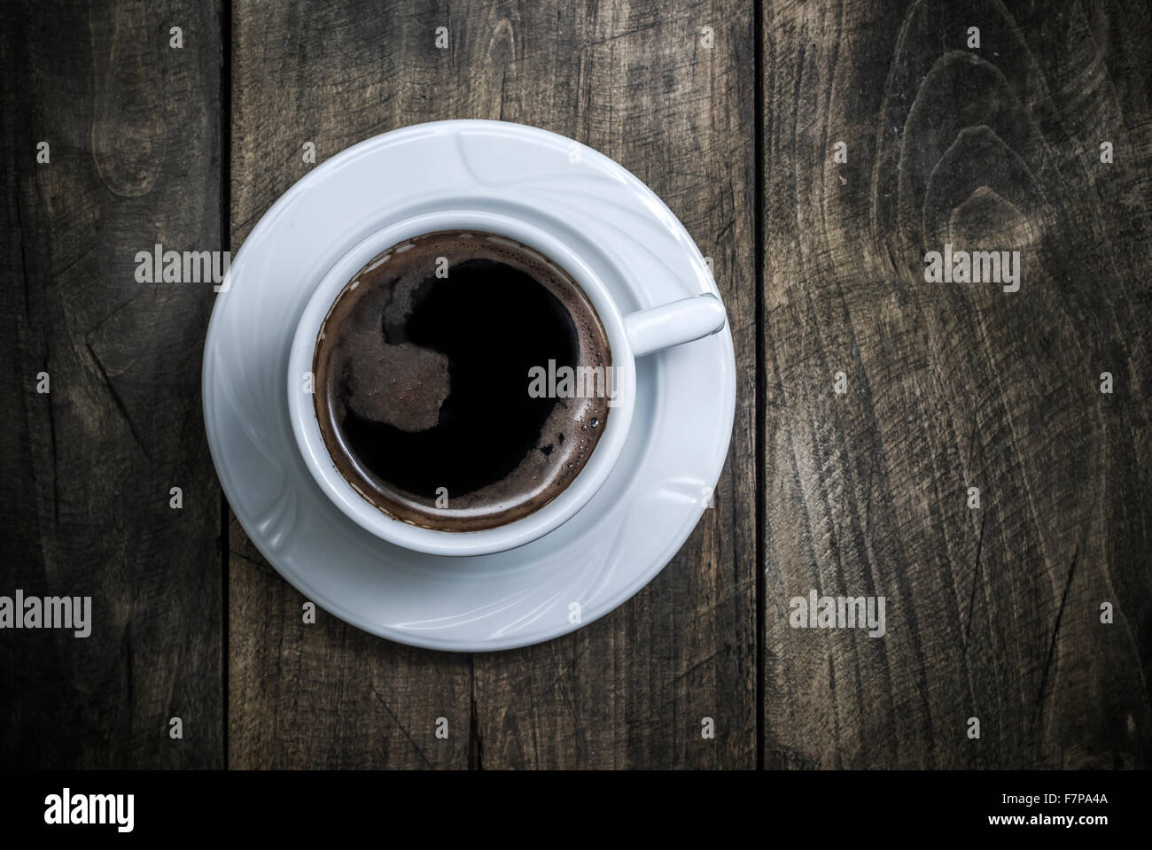Vista aerea di un preparato di fresco la tazza di caffè nero su rustico sfondo di legno Foto Stock