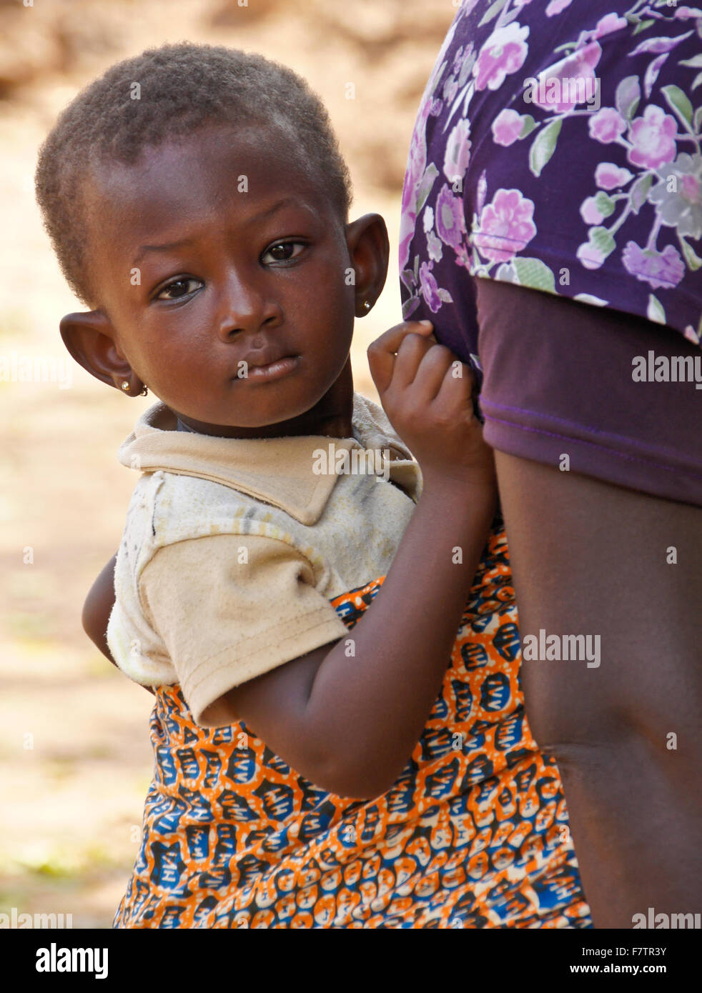 Giovani tribali Kokomba ragazza viene portato sulla madre torna, Bandjeli, Togo Foto Stock