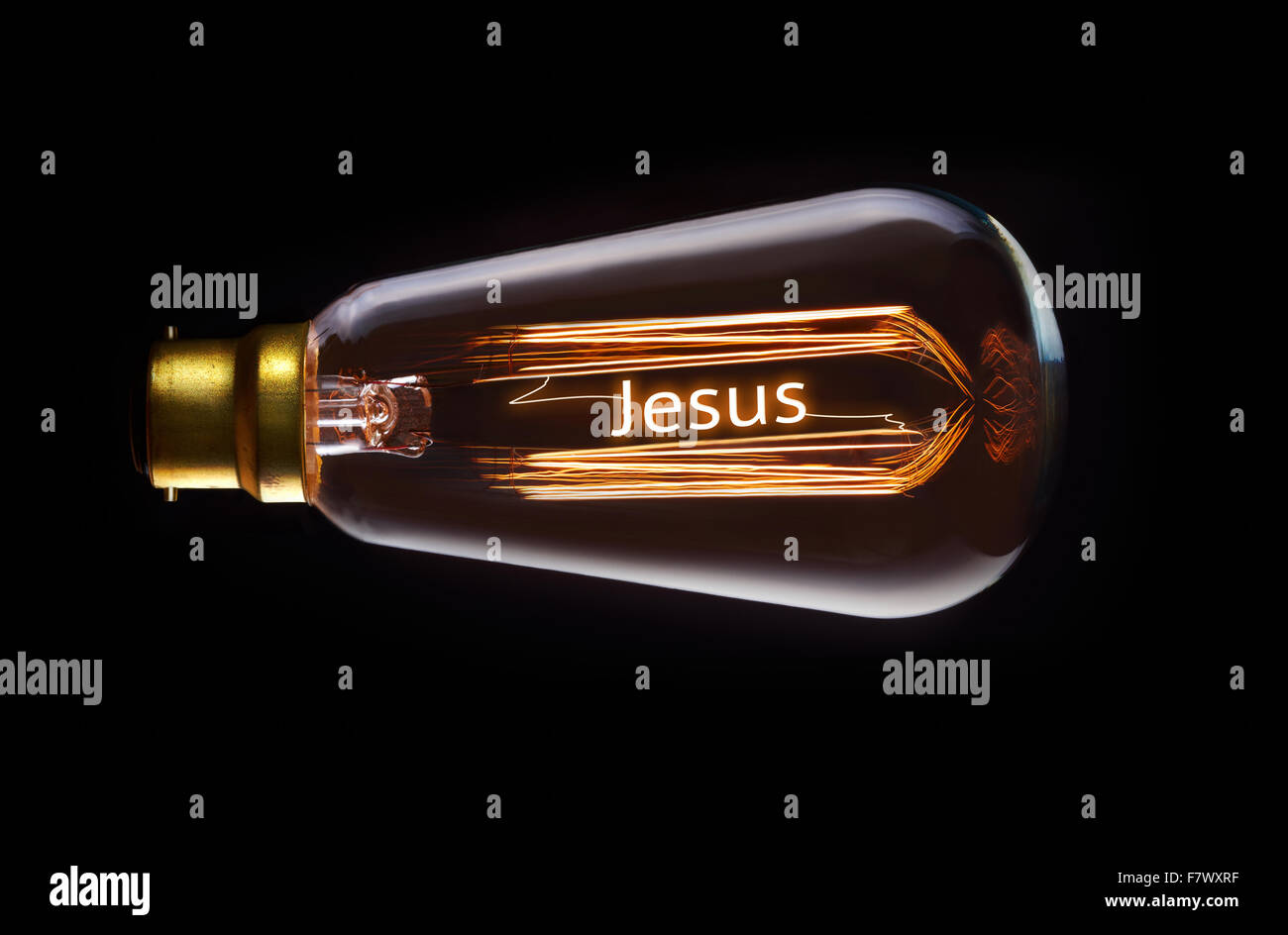 La religione di Gesù in un concetto di lampadine a filamento. Foto Stock