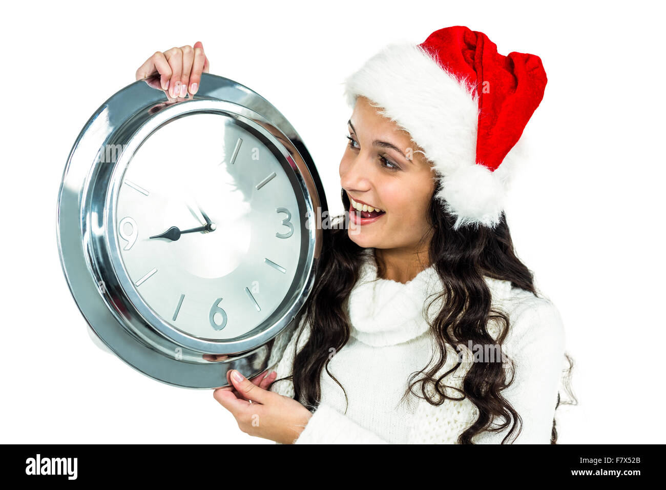 Attraente donna con cappello di Natale orologio di contenimento Foto Stock