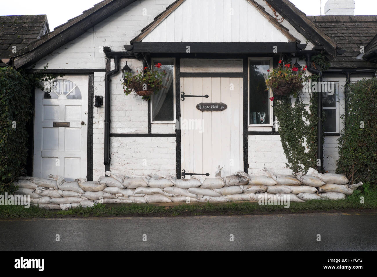 Bungalow casa home protetti da una linea di sacchi di sabbia per impedire allagamento adiacente al fiume Wye Herefordshire UK Foto Stock