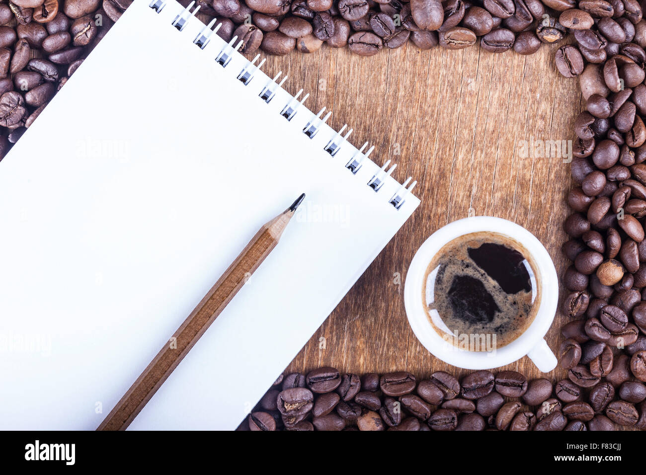 Sullo sfondo di un caffè e Blocco note sul tavolo vista superiore Foto Stock