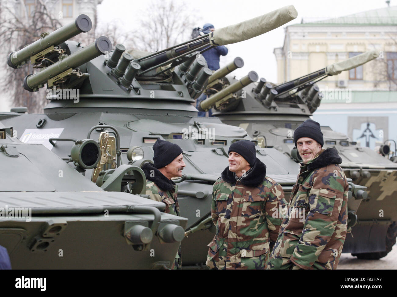 Kiev, Ucraina. 5 Dic, 2015. Uomini delle forze armate ucraine sostare vicino il BTR-3, durante la fase di apertura del militare mostra ''armi della vittoria", programmata per il giorno delle forze armate dell'Ucraina, che ha celebrato 06 dicembre, presso la parrocchia di San Michele Square, a Kiev, Ucraina, 05 dicembre, 2015. La mostra presenta ucraino personale blindato vettori BTR-3 e BTR-4 e la nuova auto blindata Dozor-B, che presto saranno inviati a est dell'Ucraina. Credito: Serg Glovny/ZUMA filo/Alamy Live News Foto Stock