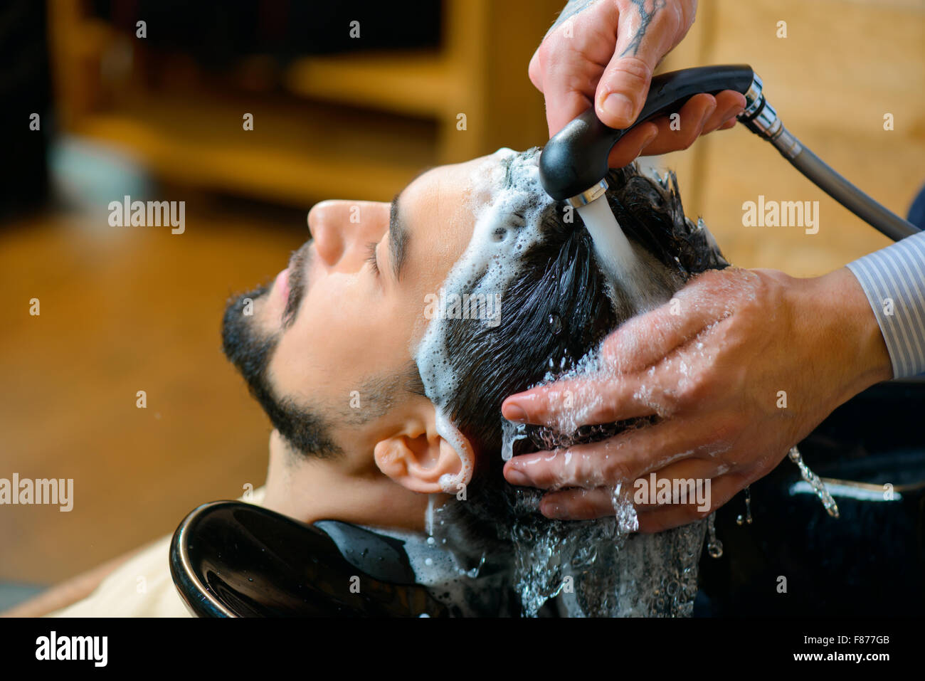 Professional barbiere il lavaggio dei capelli del cliente Foto Stock