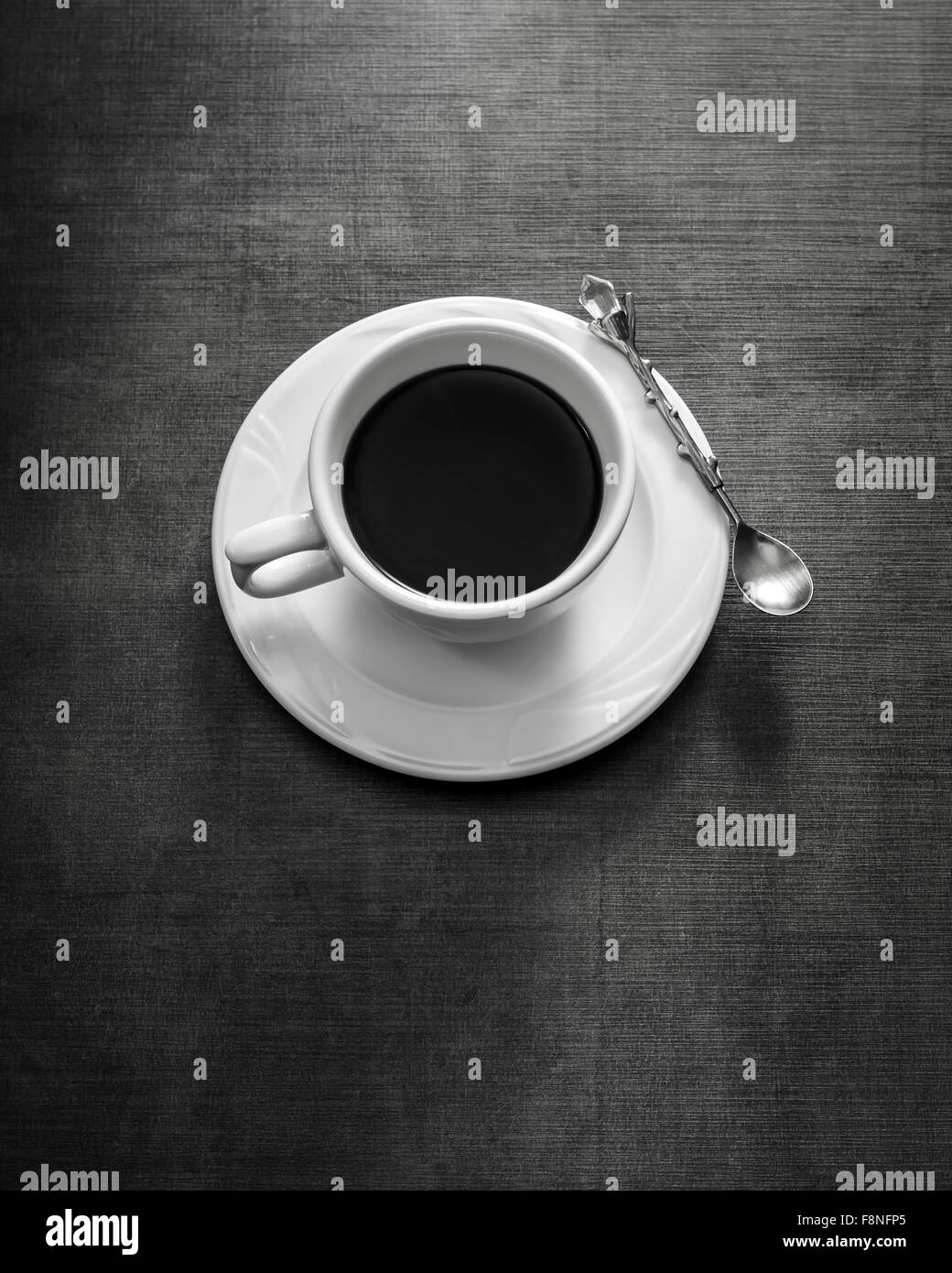 Tazza da caffè con piattino sul tavolo. In bianco e nero Foto Stock