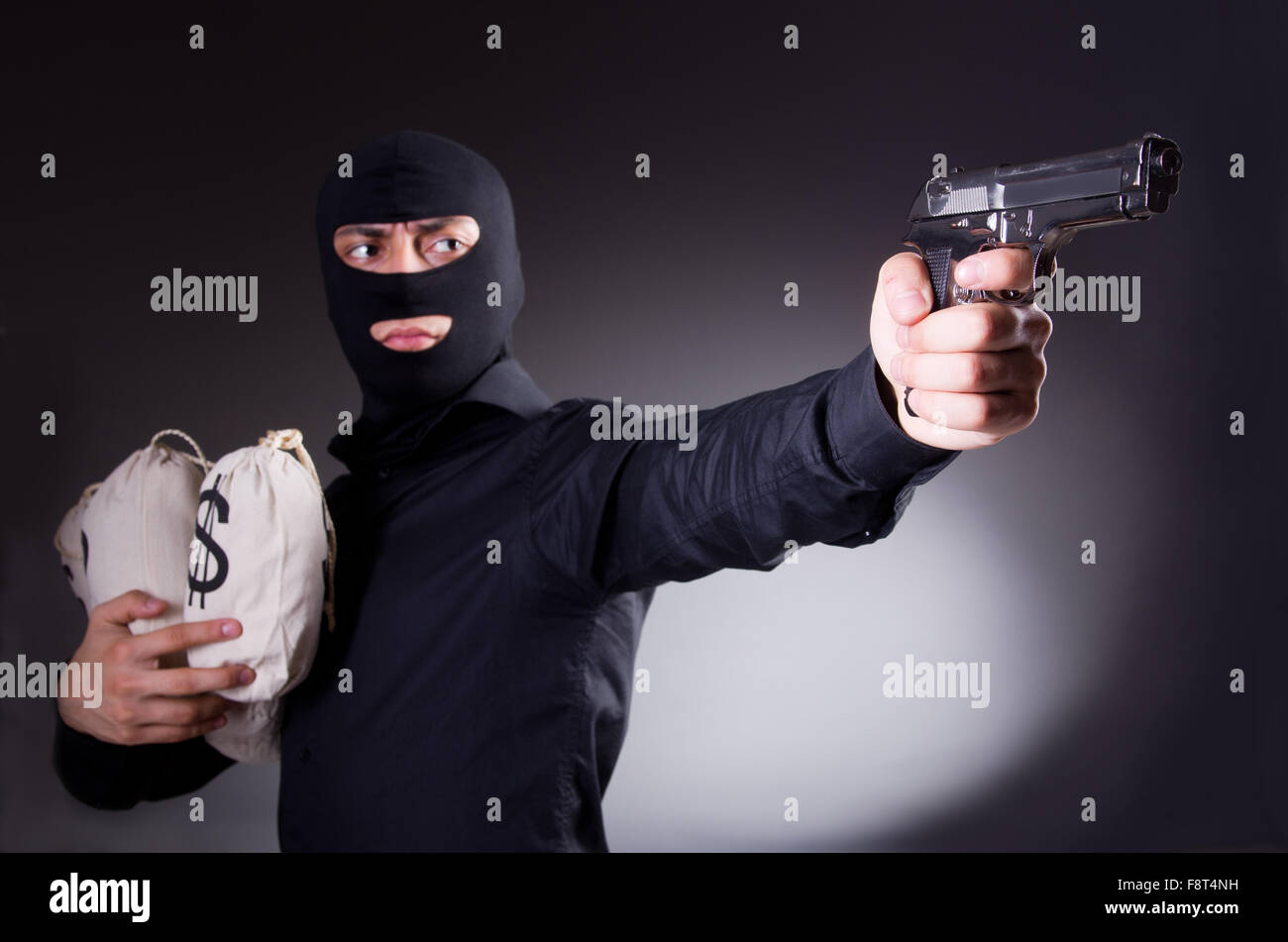 Uomo che indossa passamontagna con la pistola Foto stock - Alamy