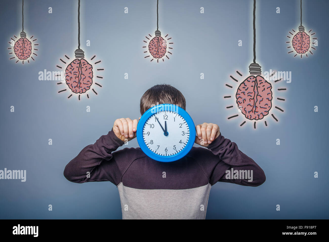 Ragazzo adolescente ha chiuso il suo orologio lampadina cervello idea creativa Foto Stock