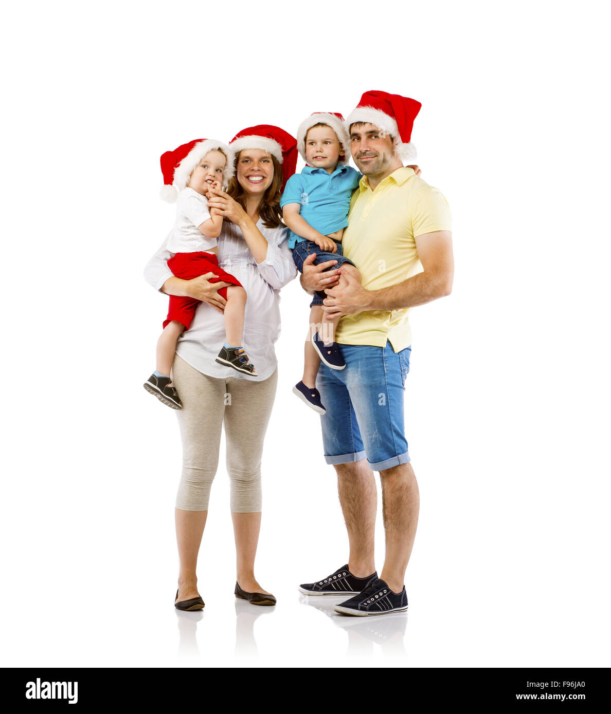 Ritratto della famiglia felice con due bambini e madri in gravidanza in natale cappelli, isolati su sfondo bianco Foto Stock