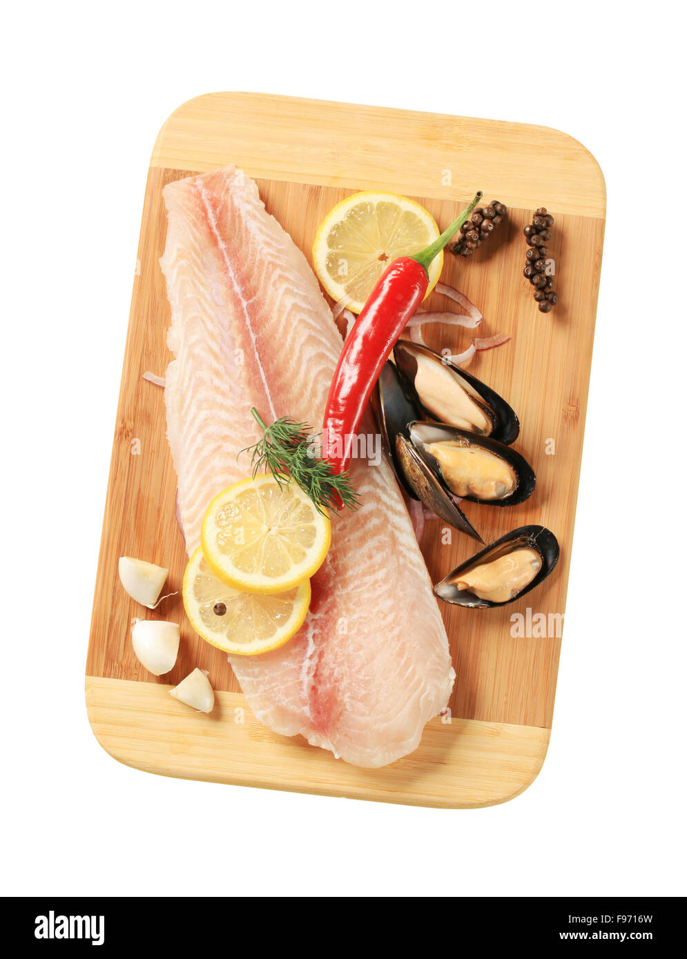 Pesce fresco e filetto di cozze su un tagliere Foto Stock