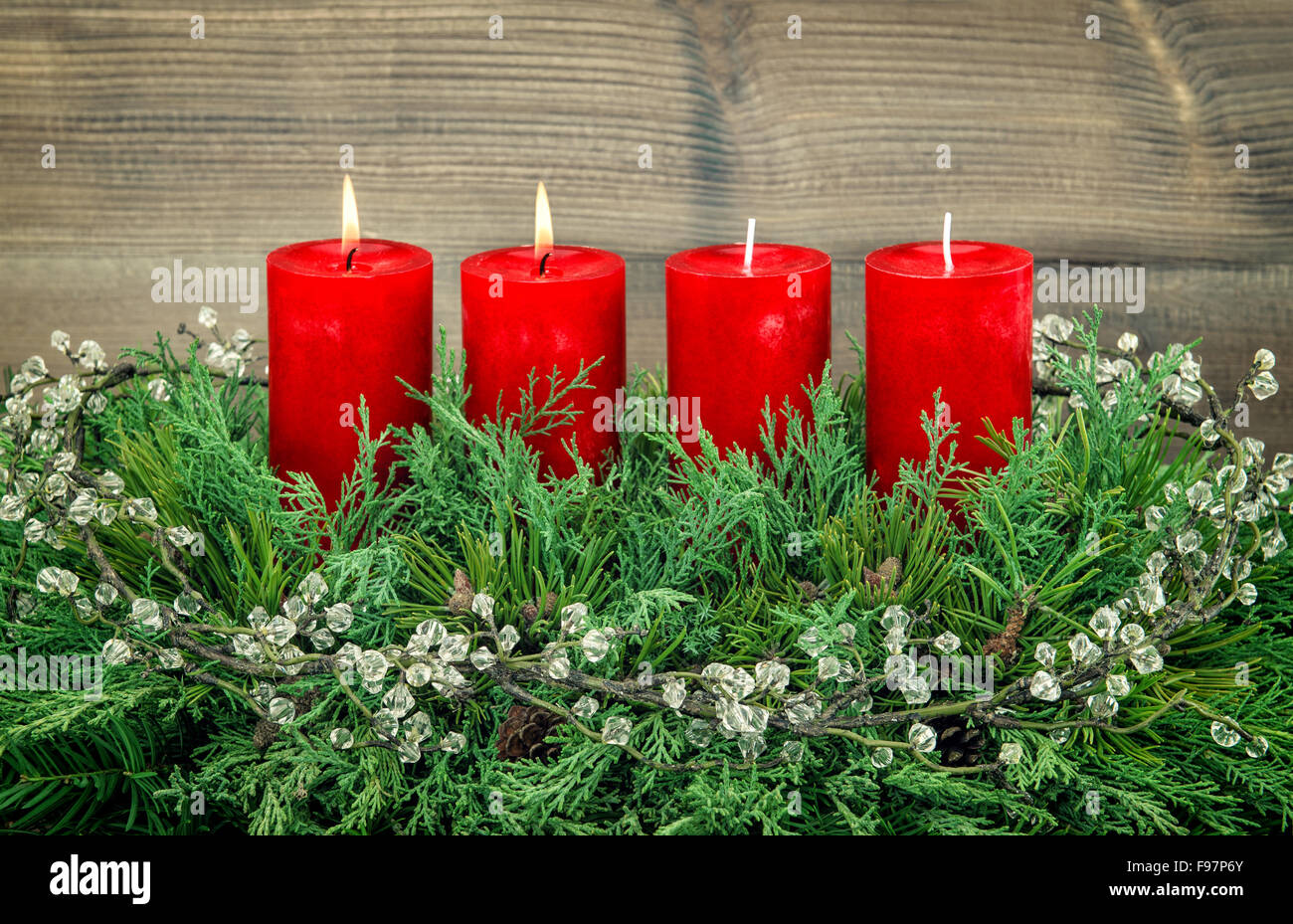 Avvento decorazione ramo di pino rosso con candele accese. Vacanze a sfondo. In stile vintage tonica foto Foto Stock