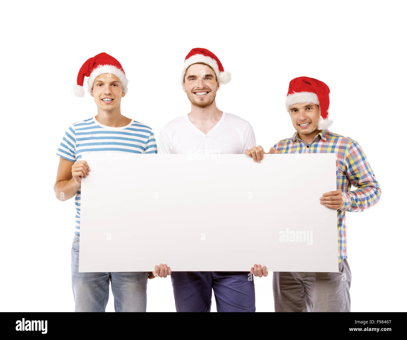 Tre giovani uomini in cappelli di Babbo Natale con copia spazio, isolati su sfondo bianco Foto Stock