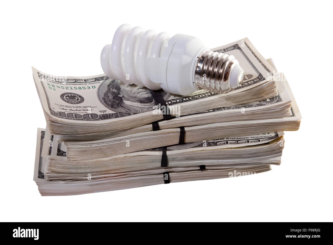 Compact luce fluorescente lampadina sul denaro. Isolato su sfondo bianco Foto Stock