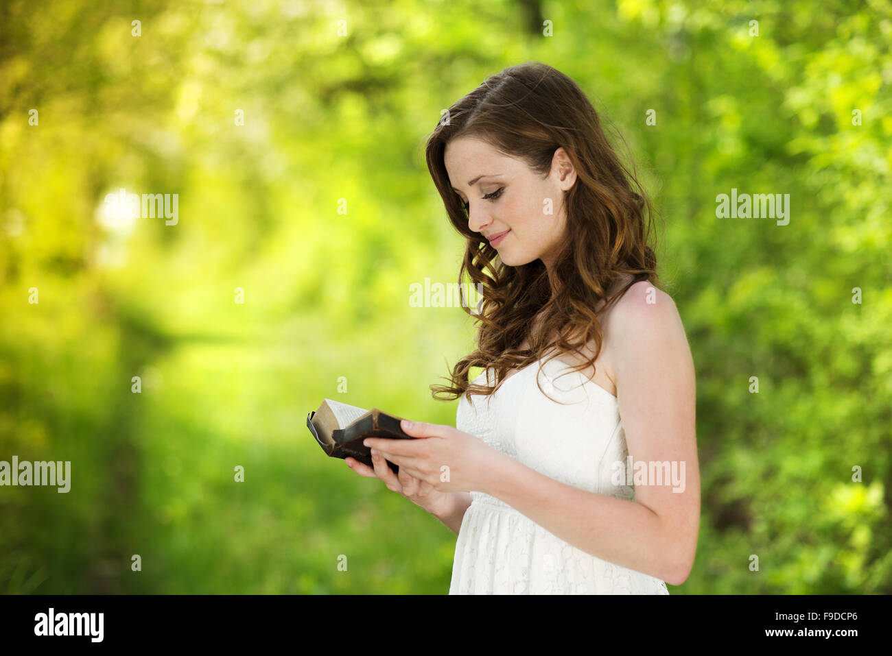 Bella donna con libro è nel carattere solare Foto Stock