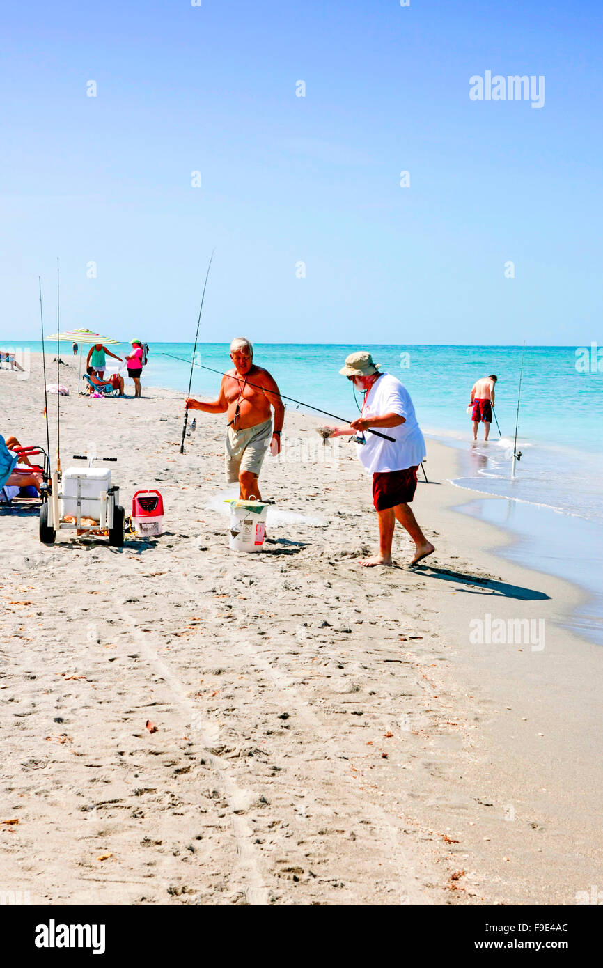 Pensionati uomini della pesca in mare dalla spiaggia a Venezia in Florida Foto Stock