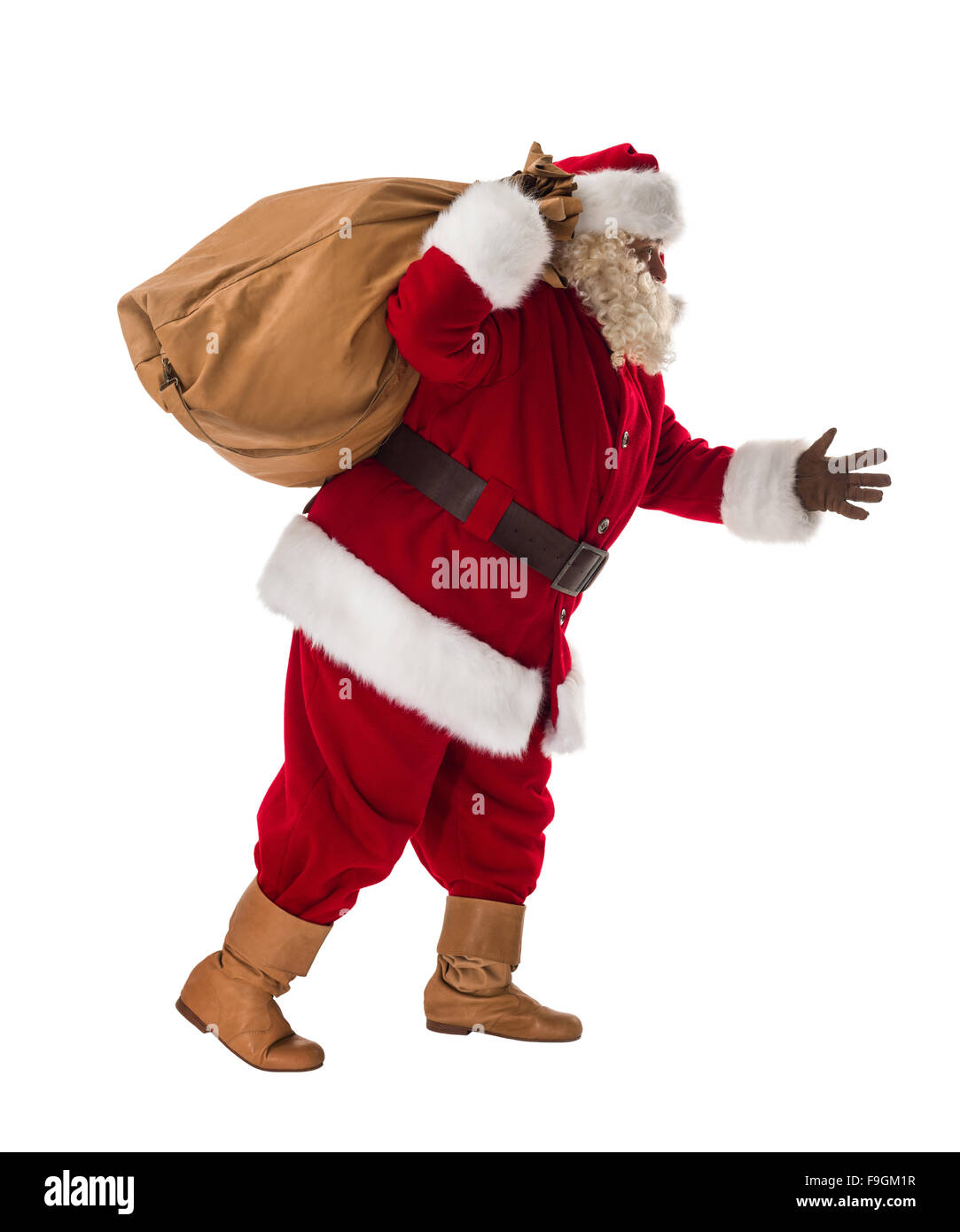 Babbo Natale a piedi con la sua grande borsa piena lunghezza Ritratto Foto Stock