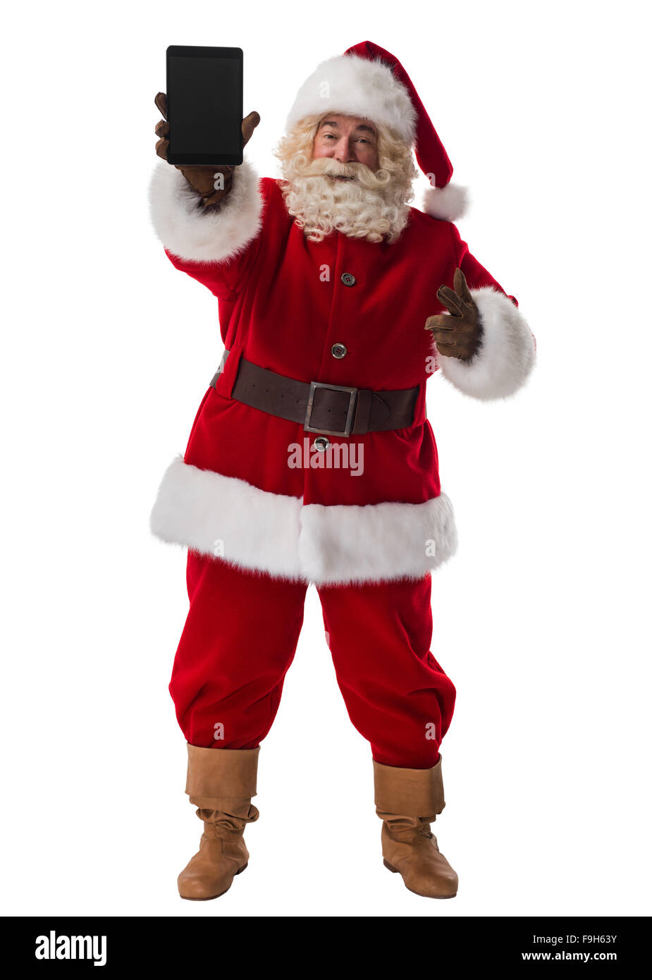 Santa Claus azienda computer tablet a piena lunghezza verticale. Isolato su sfondo bianco Foto Stock