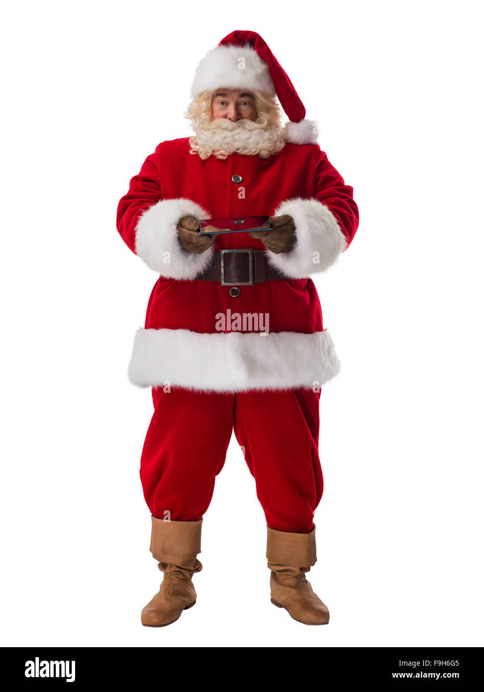 Santa Claus azienda computer tablet a piena lunghezza verticale. Isolato su sfondo bianco Foto Stock