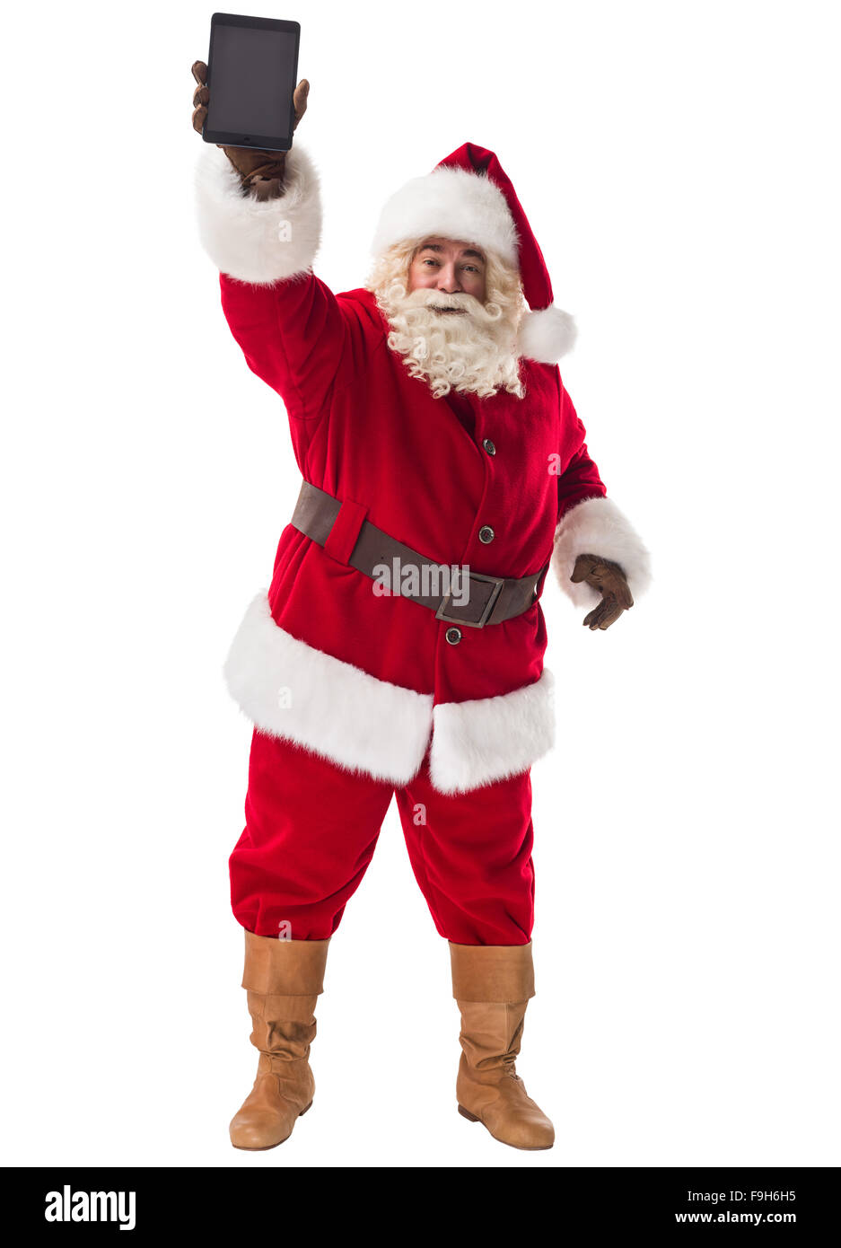 Santa Claus azienda computer tablet a piena lunghezza verticale. Isolato su sfondo bianco Foto Stock
