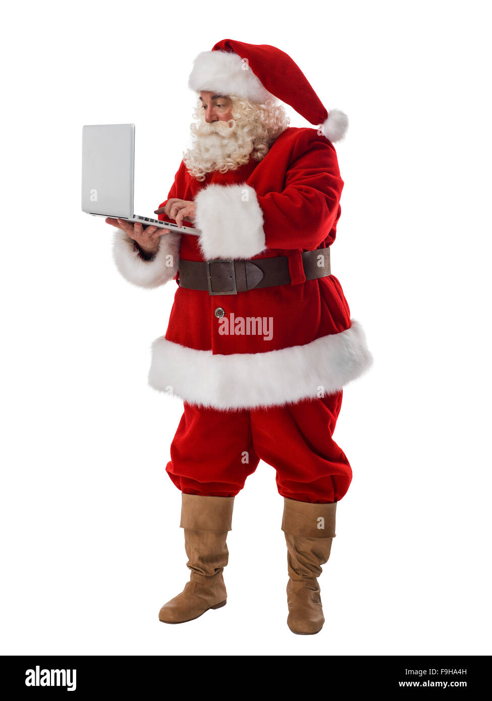 Santa Claus holding laptop a piena lunghezza verticale. Isolato su sfondo bianco Foto Stock