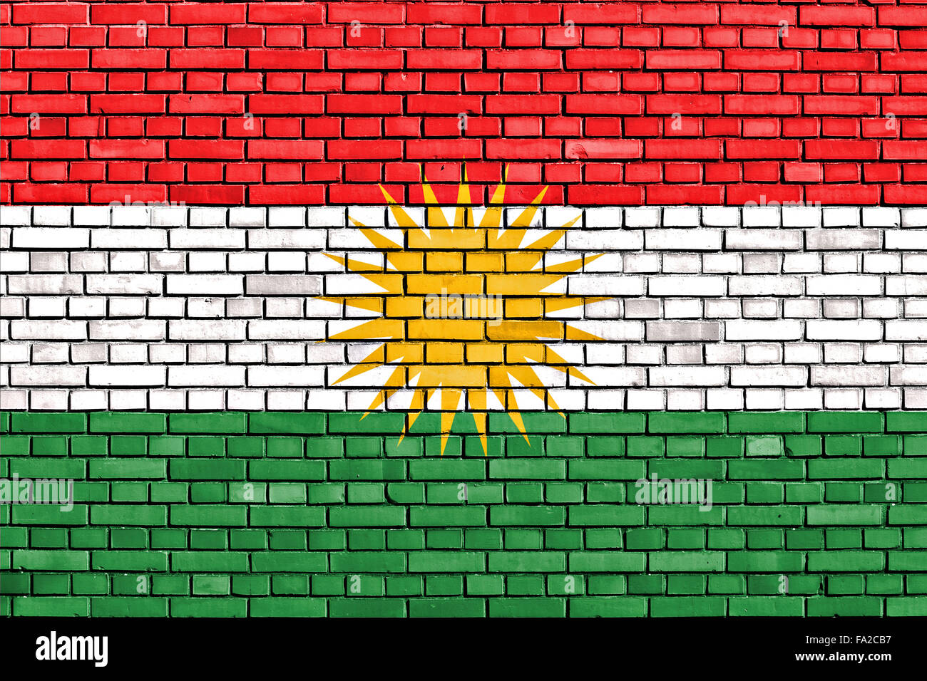 Bandiera del Kurdistan dipinta su un muro di mattoni Foto Stock