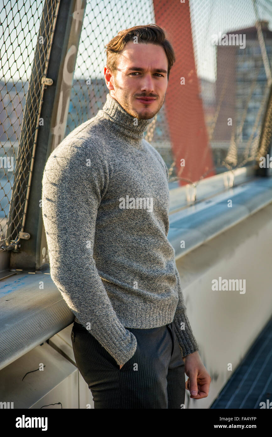 Bel giovane uomo a camminare in città, indossare abbigliamento invernale  Foto stock - Alamy