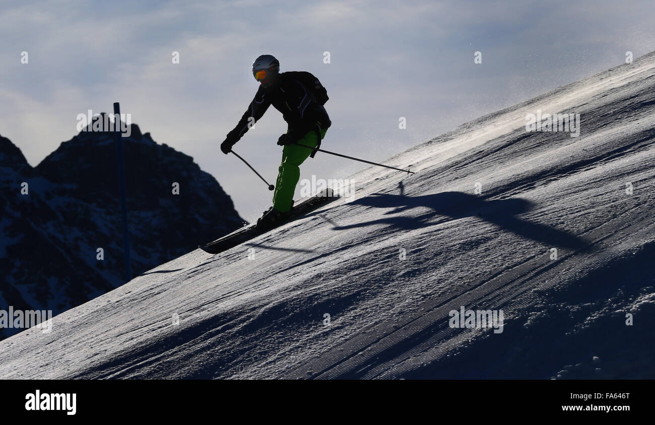 Oberstdorf, Germania. 22 Dic, 2015. Uno sciatore in azione al di sotto della stazione a metà strada si trova ad una altitudine di 1780 metri sul Fellhorn montagna vicino a Oberstdorf, Germania, 22 dicembre 2015. Anche se non vi è attualmente alcun neve per essere trovato in basso a zone pianeggianti dello stato tedesco della Baviera, lo sci e lo snowboard sono ancora possibili su un numero limitato di piste ad altitudini più alte delle Alpi Bavaresi. Foto: KARL-JOSEF HILDENBRAND/dpa/Alamy Live News Foto Stock