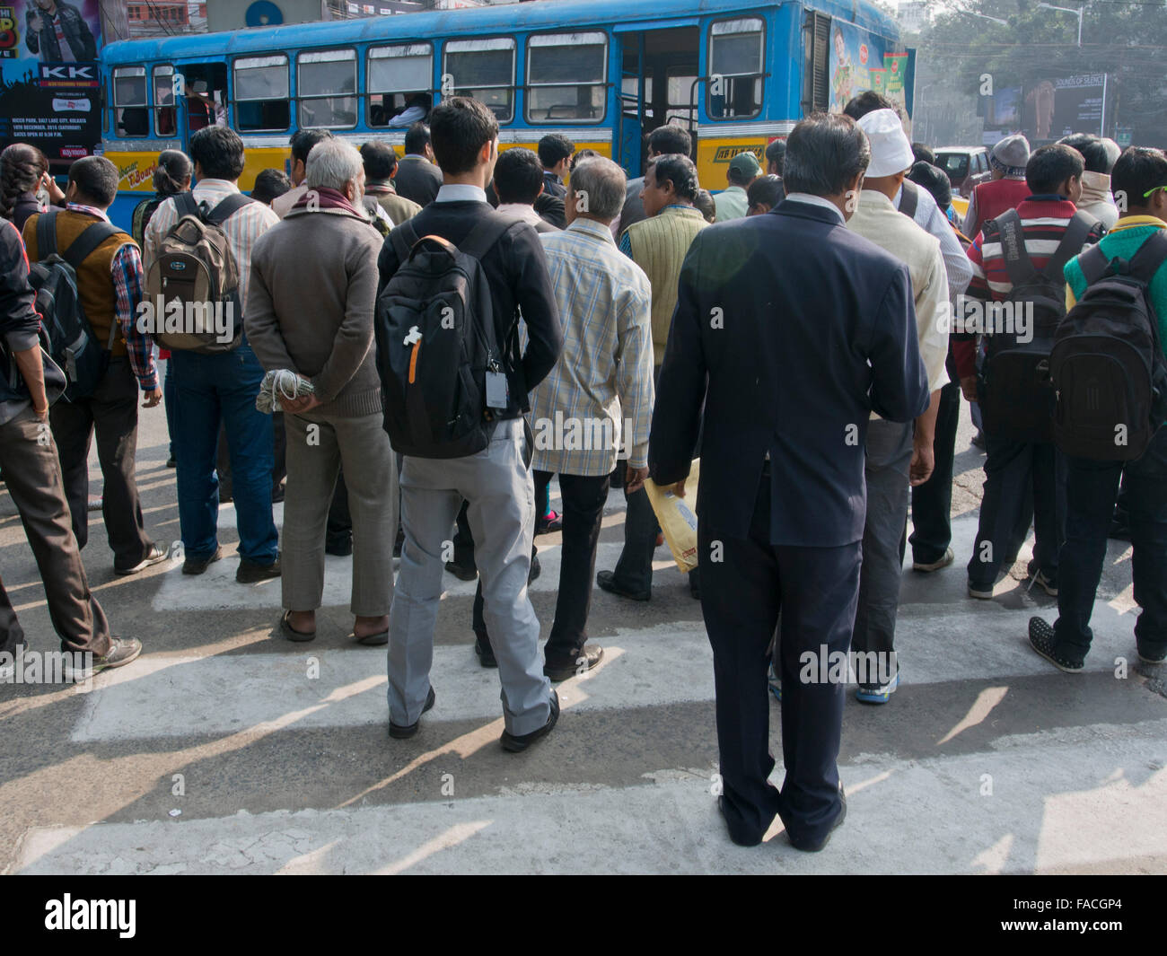 Pedoni che attraversano una strada trafficata in Kolkata, India Foto Stock