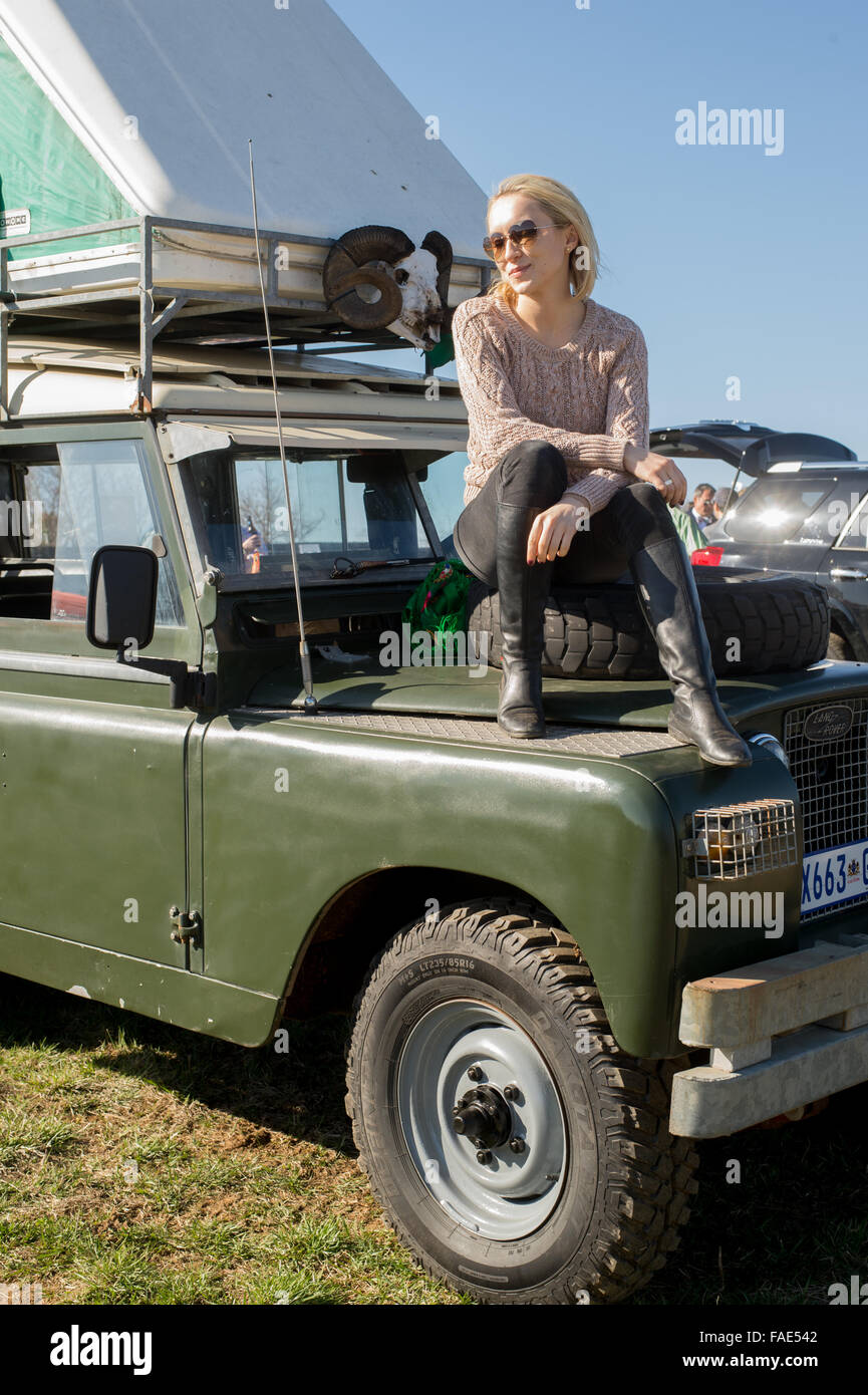 Donna seduta sulla parte superiore di un Land Rover Foto Stock
