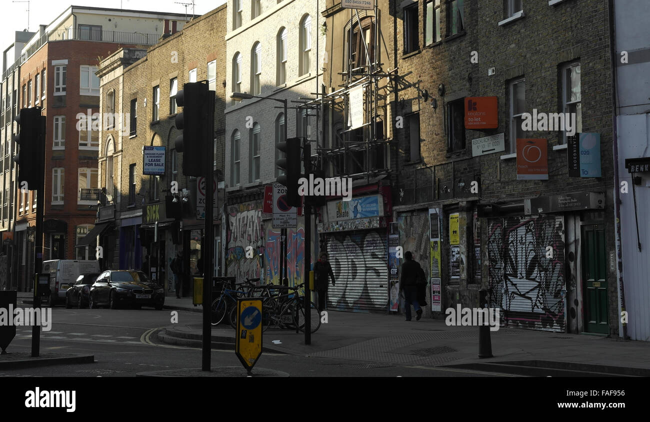 Pantina visualizza Bethnal Green Road a Brick Lane verso Redchurch Street e graffiti scrawl shop persiane, Shoreditch, Londra Foto Stock