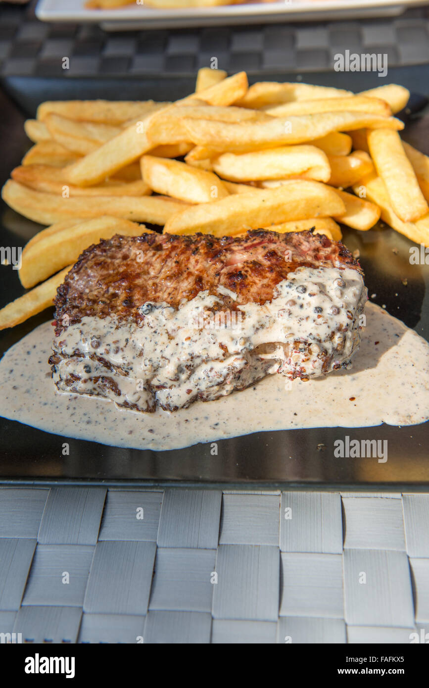 Piastra del pepati bistecca e patatine fritte nel ristorante Foto Stock