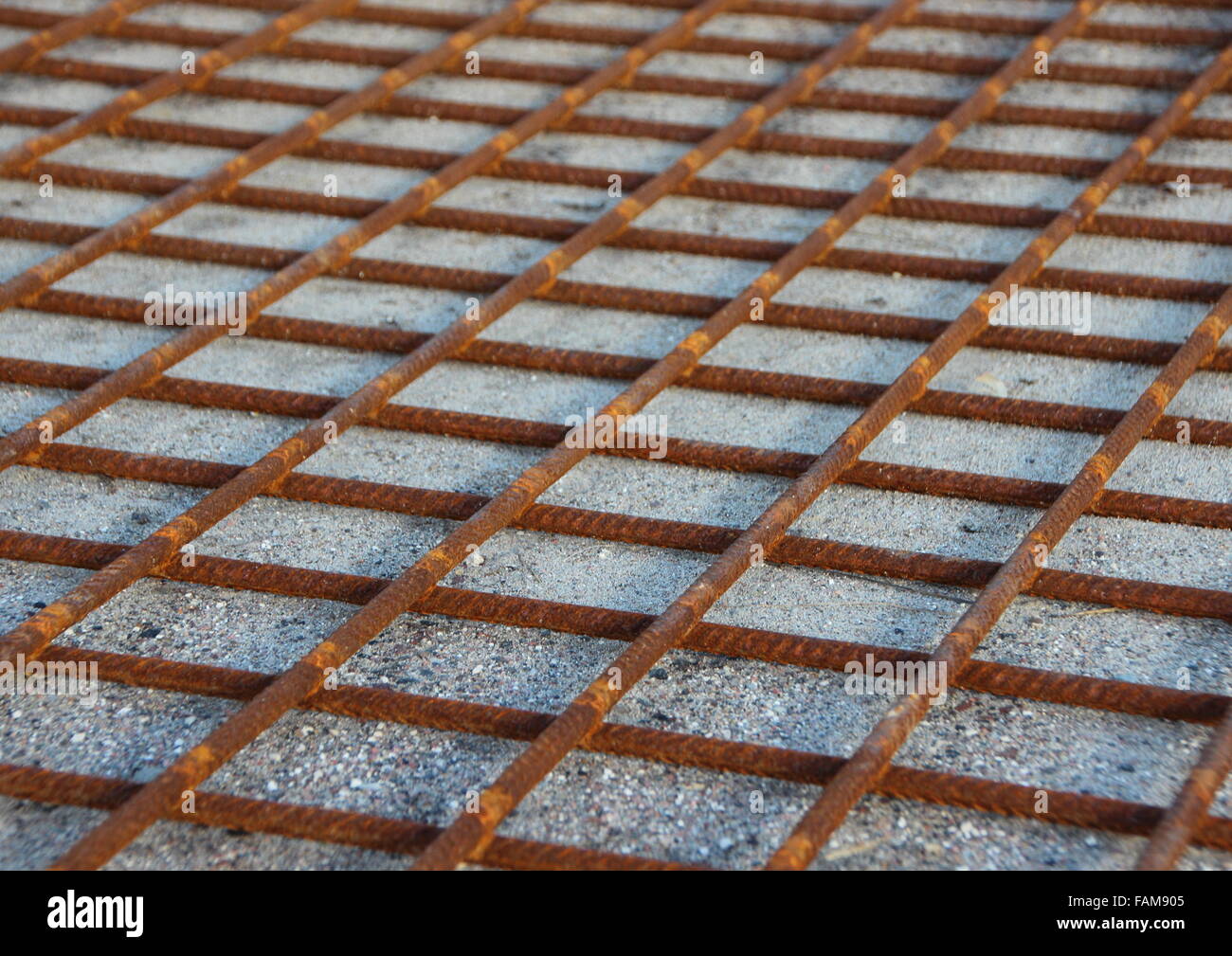 Metallo arrugginito Foundation costruzione griglia su Sfondo sabbia Foto Stock