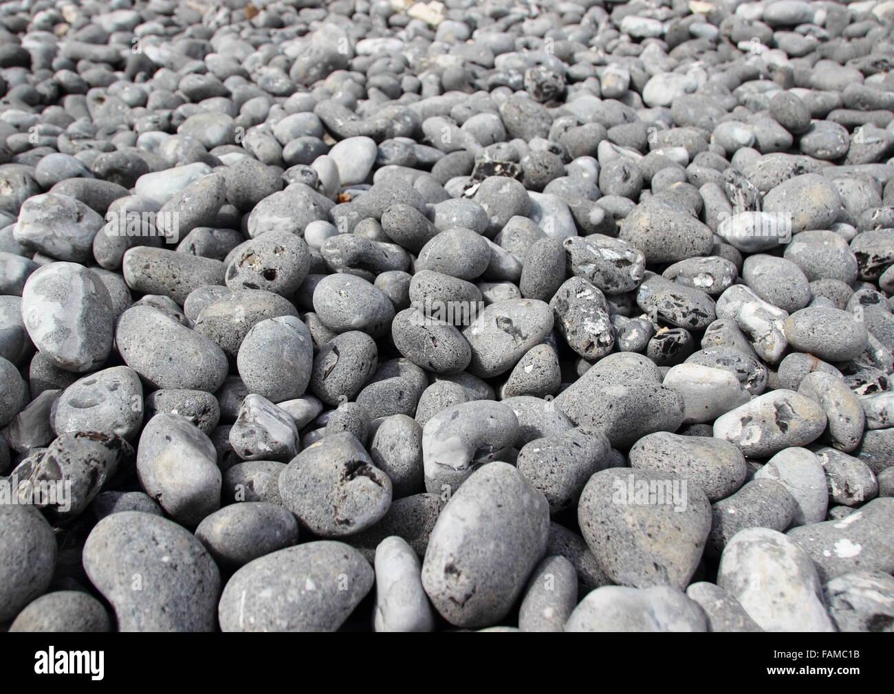 Grigio spiaggia di macerie pietre con infinite sfondo in prospettiva Foto Stock