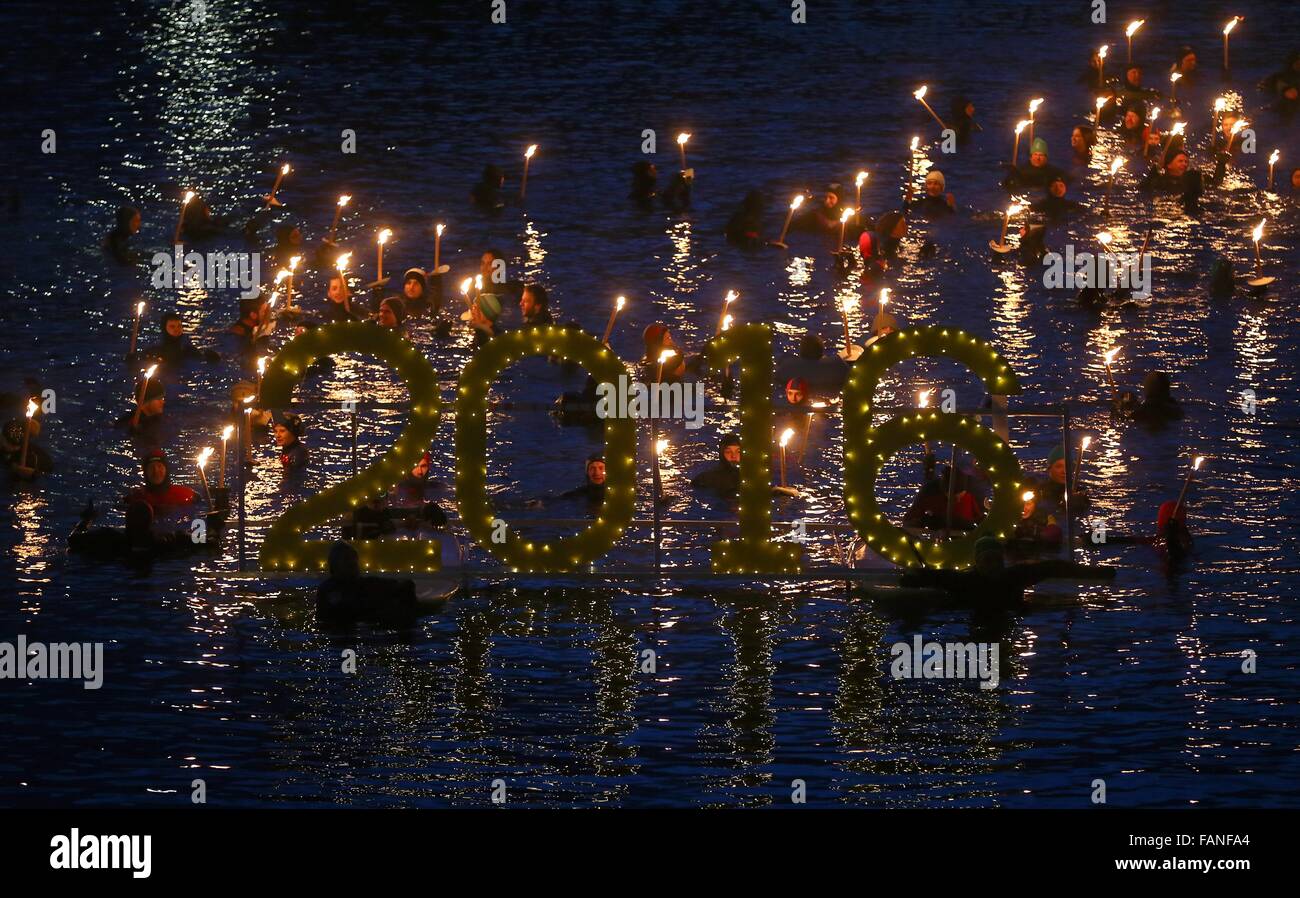 Füssen, Germania meridionale. Il 1 di gennaio 2016. Persone wade attraverso le fredde acque del fiume Lech durante la torcia tradizionale nuotare a Füssen, Germania meridionale, 01 gennaio 2016. Foto: KARL-JOSEF HILDENBRAND/dpa/Alamy Live News Foto Stock