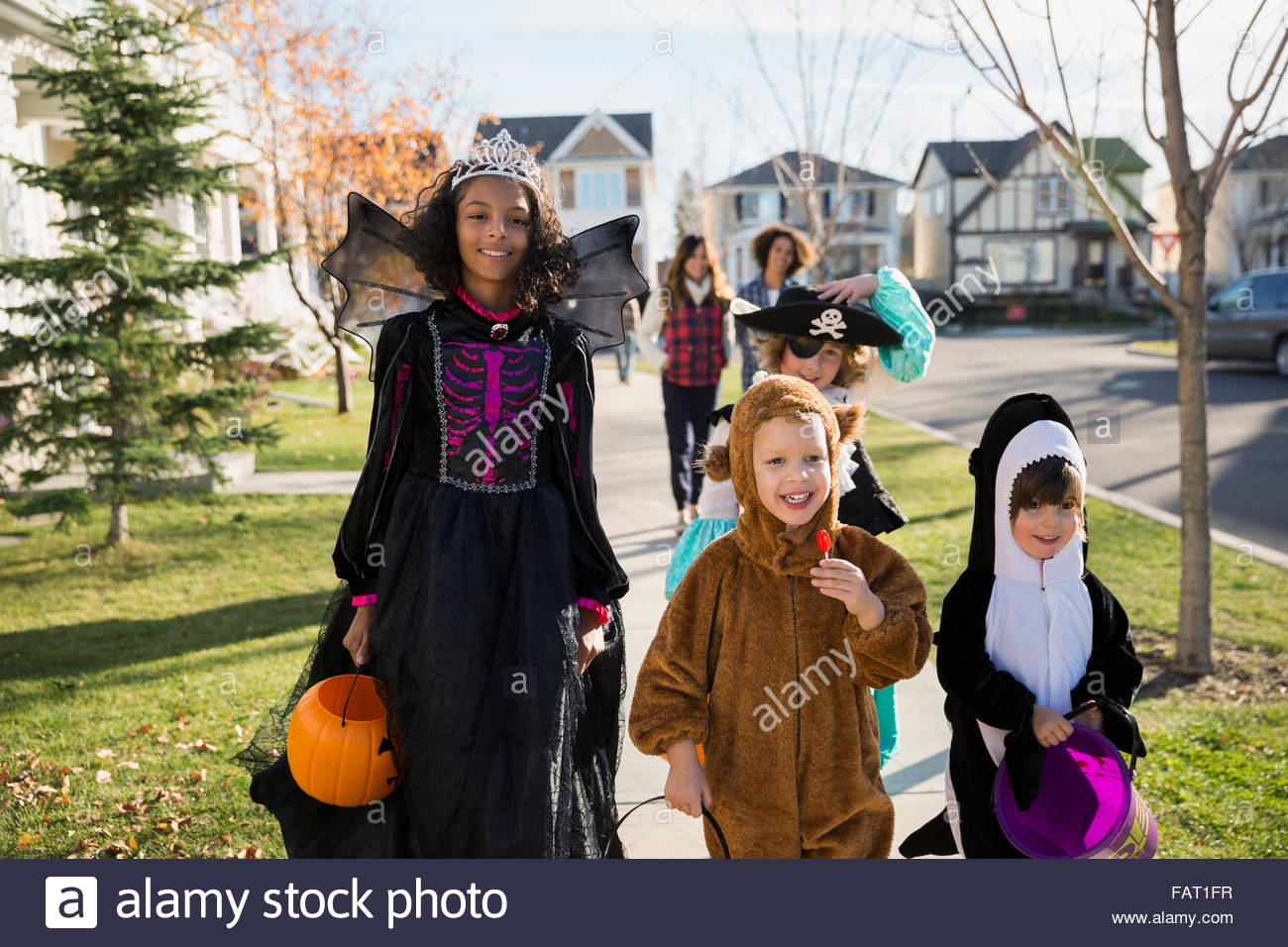 I bambini in costumi di Halloween sul marciapiede di vicinato Foto Stock