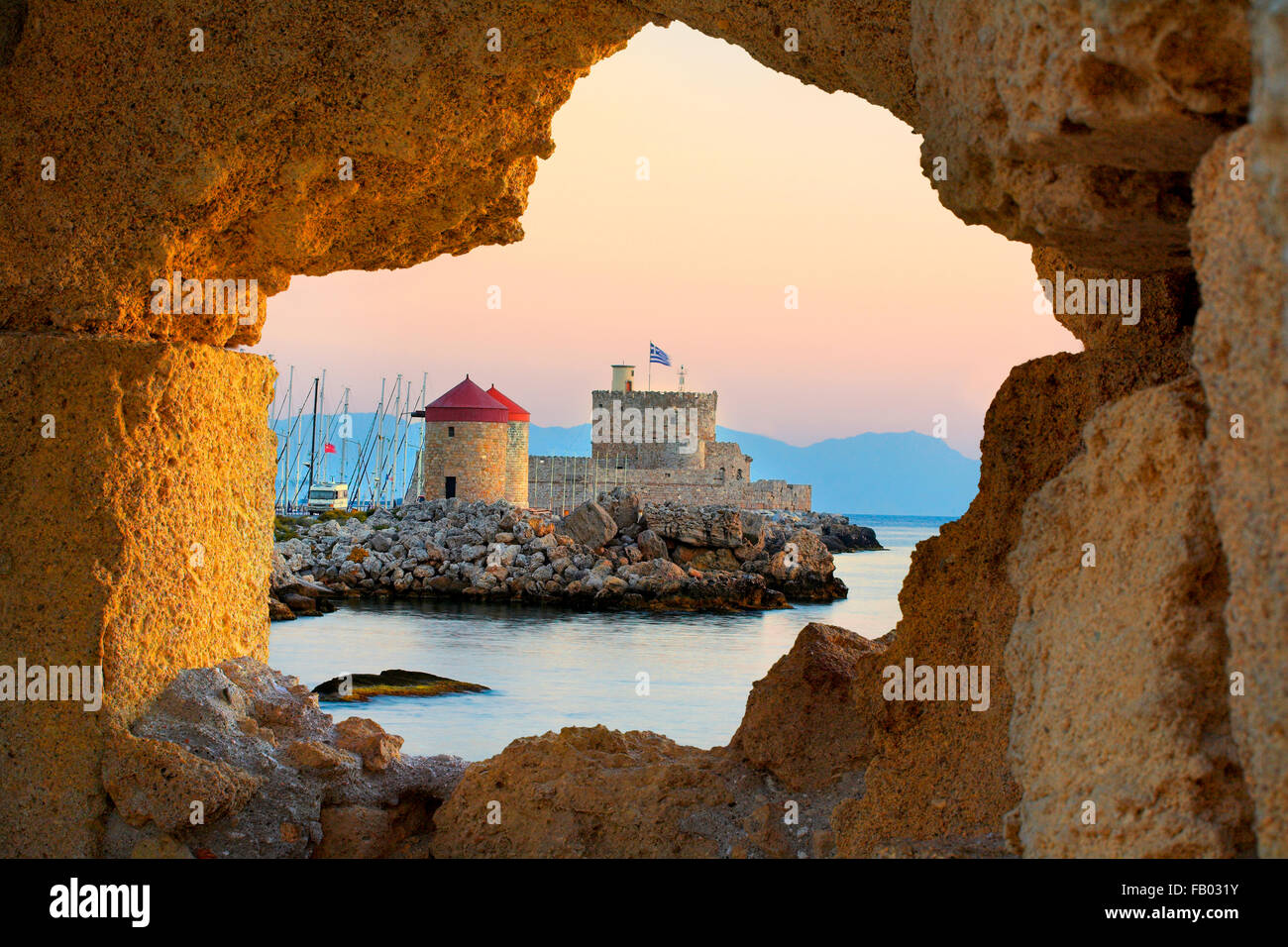 Il Castello e vecchi mulini a vento presso l'entrata di Mandrachi porto di Rodi, Grecia, UNESCO Foto Stock