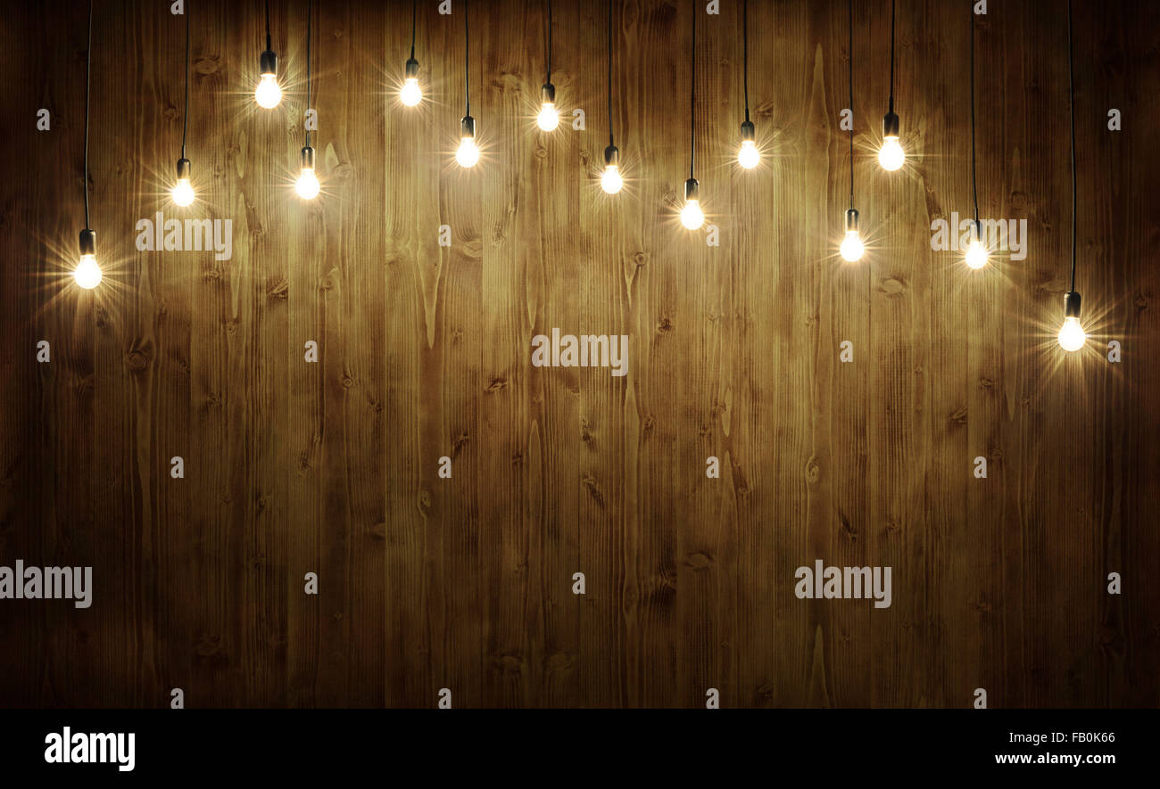 Lampadine della luce sul buio sullo sfondo di legno Foto Stock