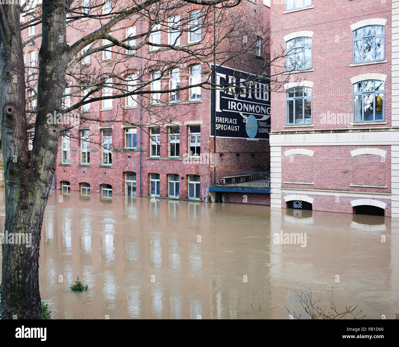 La storica "tubbs Ironmonger' edificio si riflette nell'allagato fiume Foss, Natale 2015, York, England, Regno Unito Foto Stock