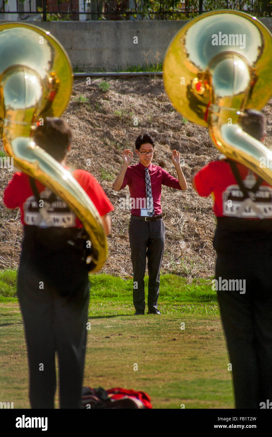 Un Vietnamese-American high school marching band direttore conduce la sua multirazziale tuba i giocatori in pratica prima di una banda in concorso Mission Viejo, CA. Foto Stock