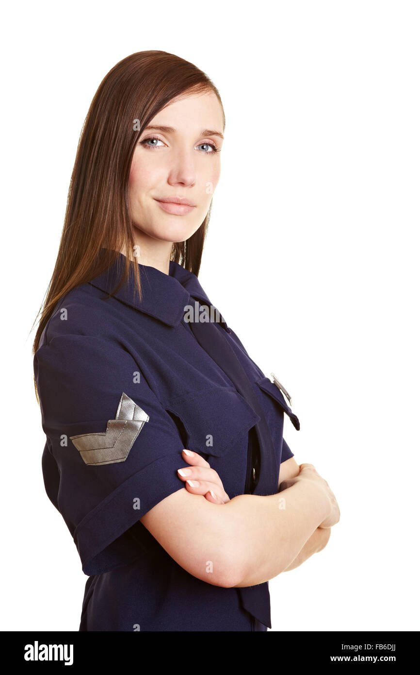 Giovani donne poliziotto sorridente con le braccia incrociate Foto Stock
