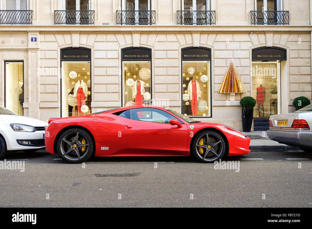 Ferrari 458 parcheggiate nella parte anteriore del negozio di moda Maison Ullens. maglieria, Parigi, Francia. Foto Stock