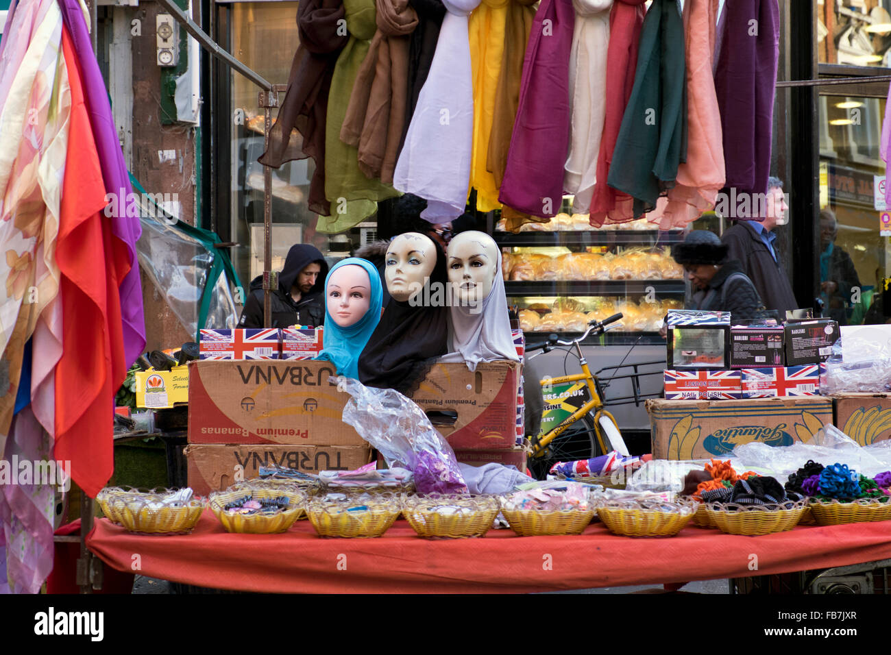 Stallo del mercato vendendo sciarpe e ninnoli Brixton a sud di Londra Foto Stock