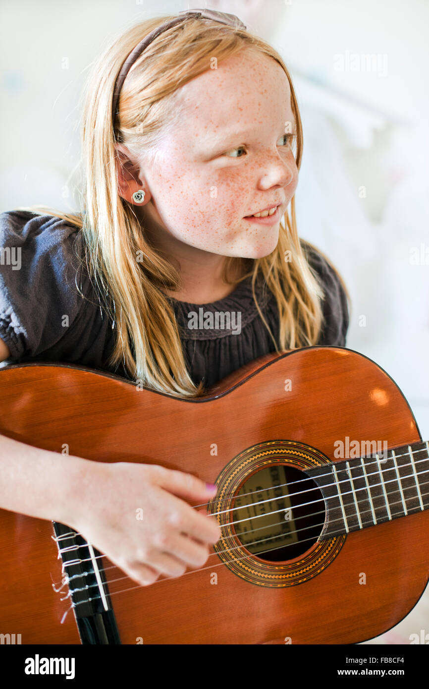 La Svezia, ragazza (8-9) a suonare la chitarra Foto Stock